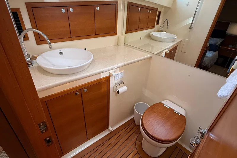  Yacht Photos Pics Luxurious bathroom in 2017 Grand Banks 44 Eastbay SX yacht with wooden accents.
