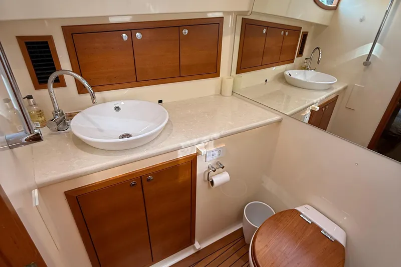  Yacht Photos Pics Luxurious bathroom in 2017 Grand Banks 44 Eastbay SX yacht with elegant wood accents.