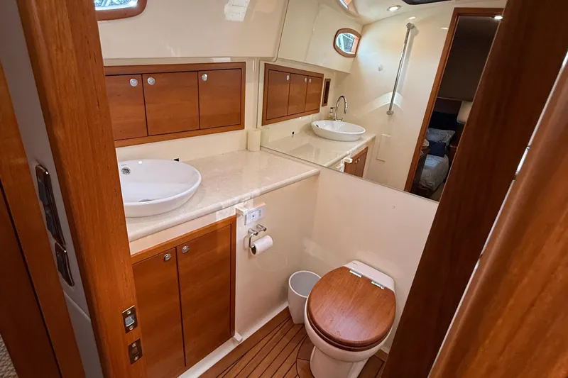  Yacht Photos Pics Luxurious bathroom in 2017 Grand Banks 44 Eastbay SX yacht with wooden cabinetry.