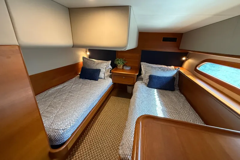  Yacht Photos Pics 2017 Grand Banks 44 Eastbay SX cabin with twin beds, elegant wood finish, and nautical decor.
