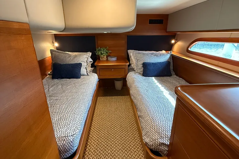  Yacht Photos Pics Twin cabin interior of 2017 Grand Banks 44 Eastbay SX yacht, featuring elegant wood finishes.