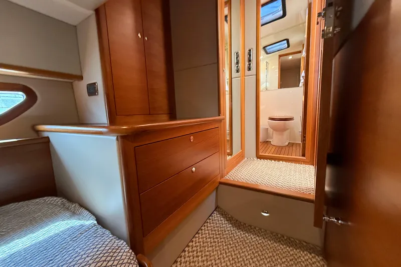  Yacht Photos Pics 2017 Grand Banks 44 Eastbay SX interior with wood cabinetry and bathroom view.