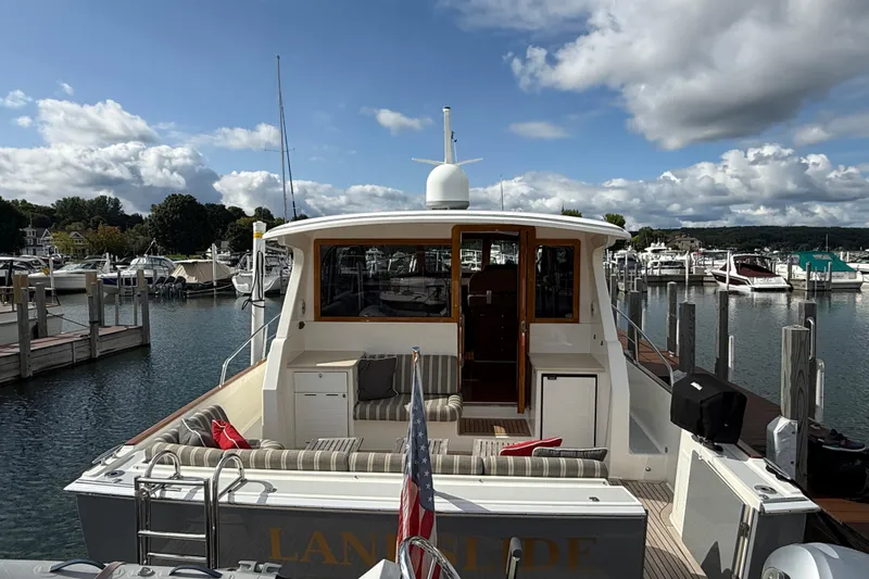  Yacht Photos Pics 2017 Grand Banks 44 Eastbay SX yacht docked at a marina under a partly cloudy sky.