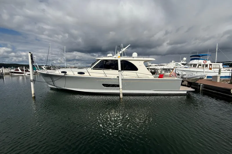  Yacht Photos Pics 2017 Grand Banks 44 Eastbay SX yacht docked at marina under cloudy sky.
