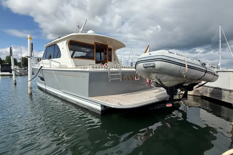  Yacht Photos Pics 2017 Grand Banks 44 Eastbay SX yacht docked with inflatable boat on stern.