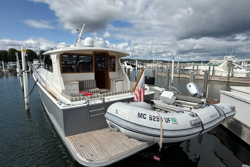  Yacht Photos Pics 2017 Grand Banks 44 Eastbay SX yacht docked with inflatable boat attached.