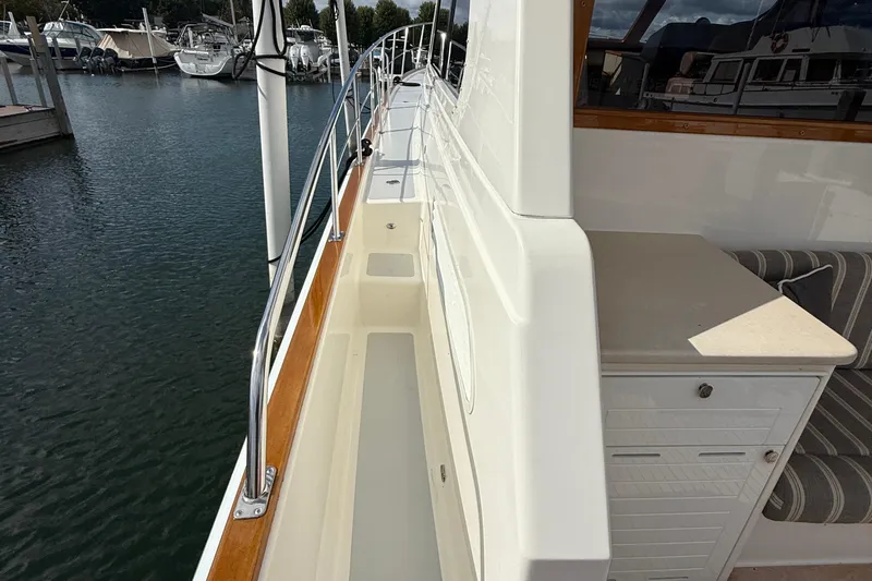  Yacht Photos Pics 2017 Grand Banks 44 Eastbay SX yacht deck with railing and seating area.