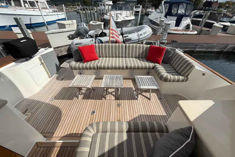  Yacht Photos Pics Luxurious 2017 Grand Banks 44 Eastbay SX yacht with elegant deck seating and marina view.