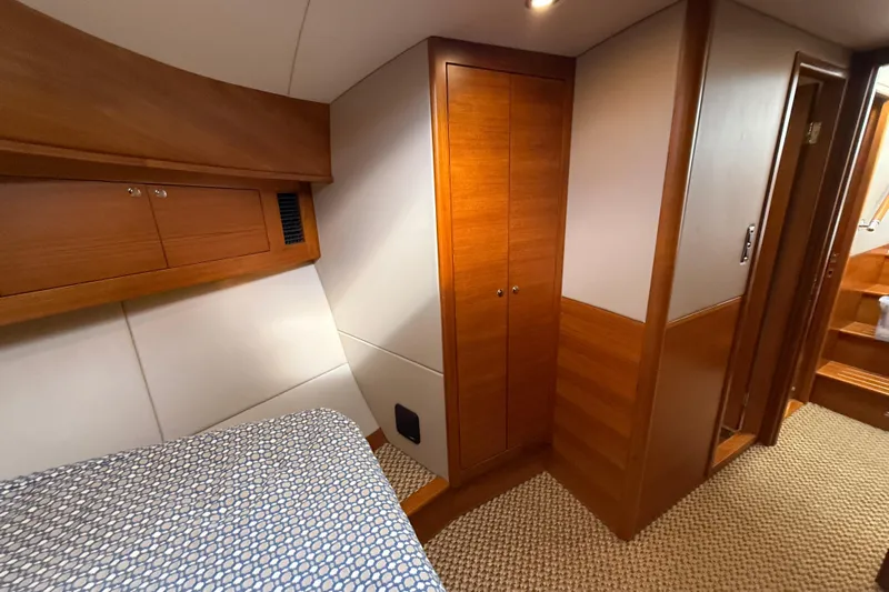  Yacht Photos Pics Luxurious cabin interior of 2017 Grand Banks 44 Eastbay SX yacht with wooden finishes.