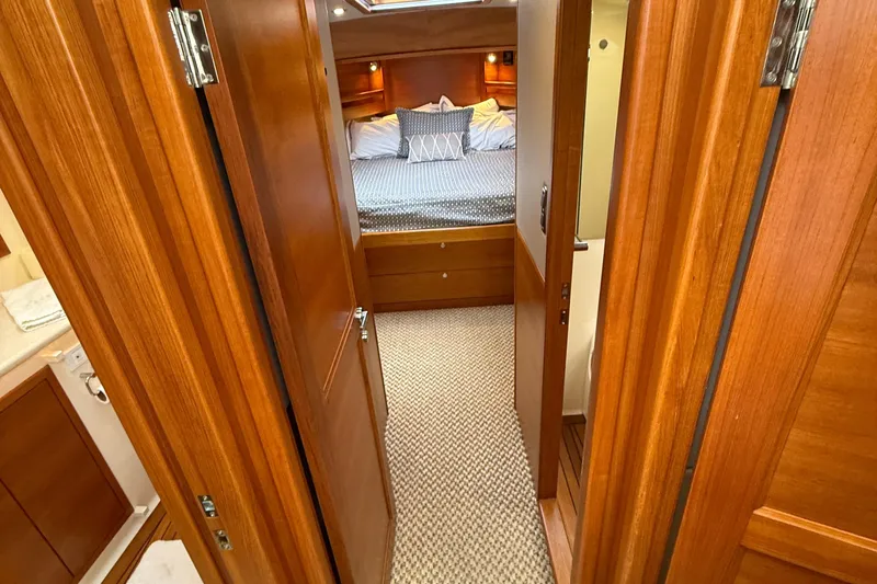  Yacht Photos Pics Luxurious 2017 Grand Banks 44 Eastbay SX yacht interior with cozy bedroom and wooden finishes.