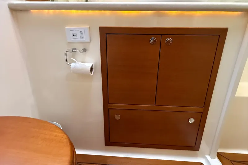  Yacht Photos Pics 2017 Grand Banks 44 Eastbay SX interior with wooden cabinetry and wall-mounted accessories.