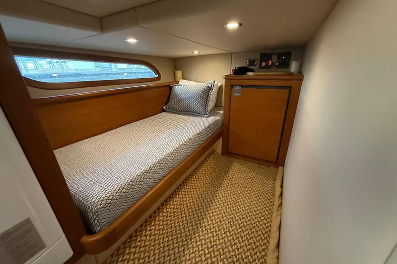  Yacht Photos Pics 2017 Grand Banks 44 Eastbay SX cabin with single bed and wooden cabinetry.