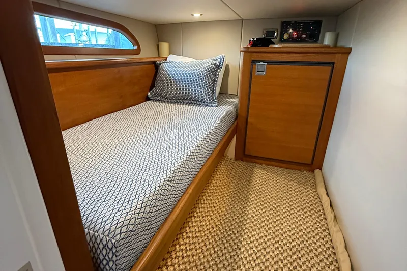  Yacht Photos Pics 2017 Grand Banks 44 Eastbay SX cabin with single bed and wooden cabinetry.