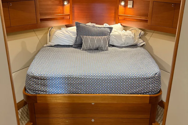  Yacht Photos Pics Cozy bedroom interior of 2017 Grand Banks 44 Eastbay SX yacht with wooden accents.