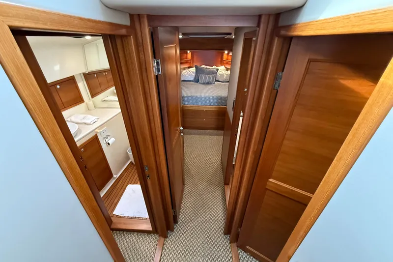  Yacht Photos Pics 2017 Grand Banks 44 Eastbay SX interior with wood finish, showing bedroom and bathroom.
