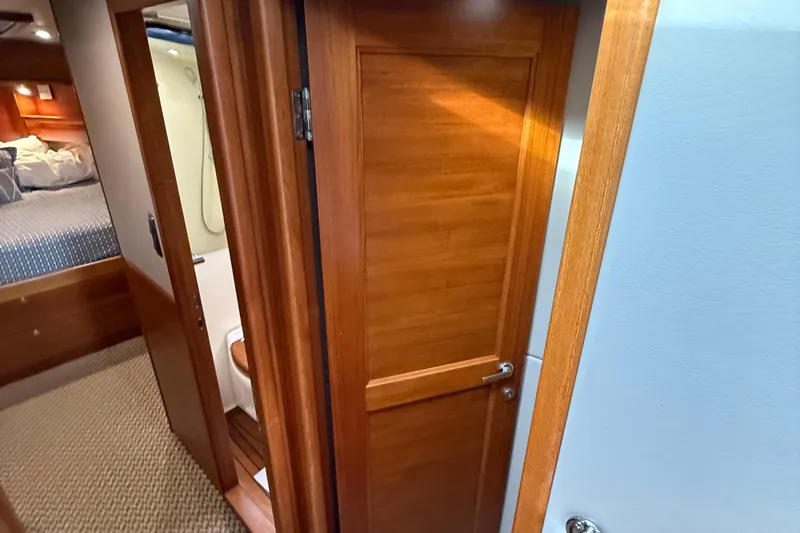  Yacht Photos Pics Interior of 2017 Grand Banks 44 Eastbay SX yacht, featuring wooden doors and cozy cabin.