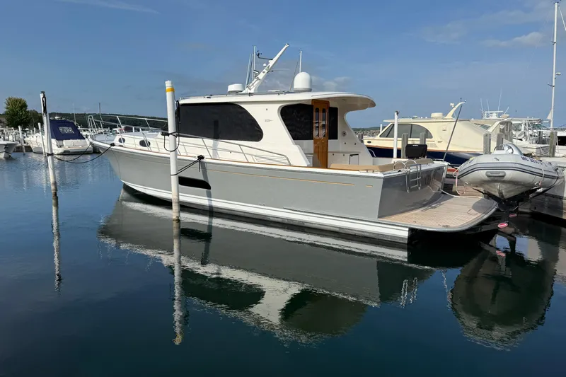  Yacht Photos Pics 2017 Grand Banks 44 Eastbay SX yacht docked in a marina, reflecting on calm water.