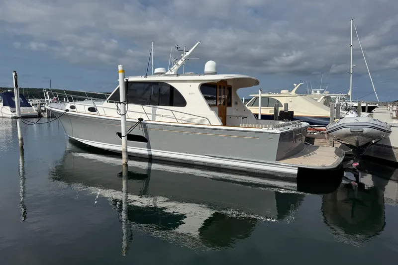  Yacht Photos Pics 2017 Grand Banks 44 Eastbay SX yacht docked in a marina under cloudy skies.