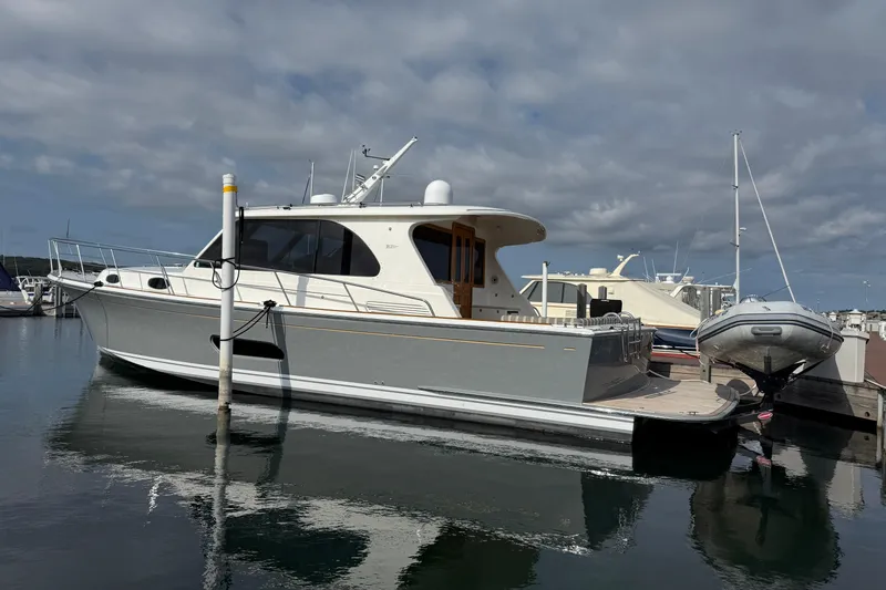  Yacht Photos Pics 2017 Grand Banks 44 Eastbay SX yacht docked in a marina under cloudy skies.