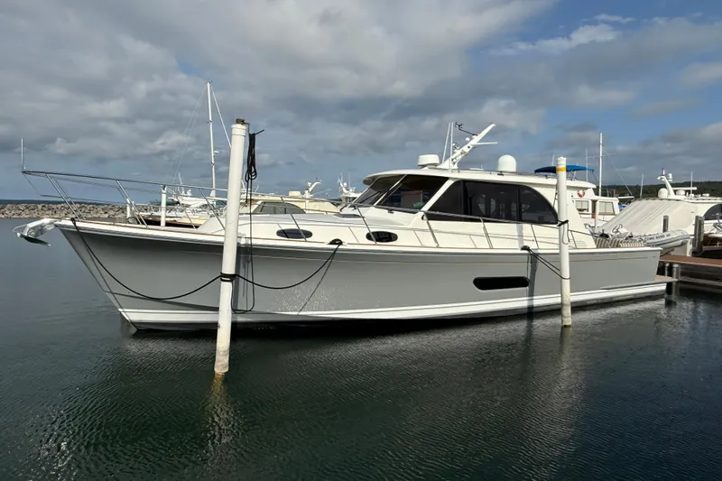  Yacht Photos Pics 2017 Grand Banks 44 Eastbay SX yacht docked in a marina under cloudy skies.