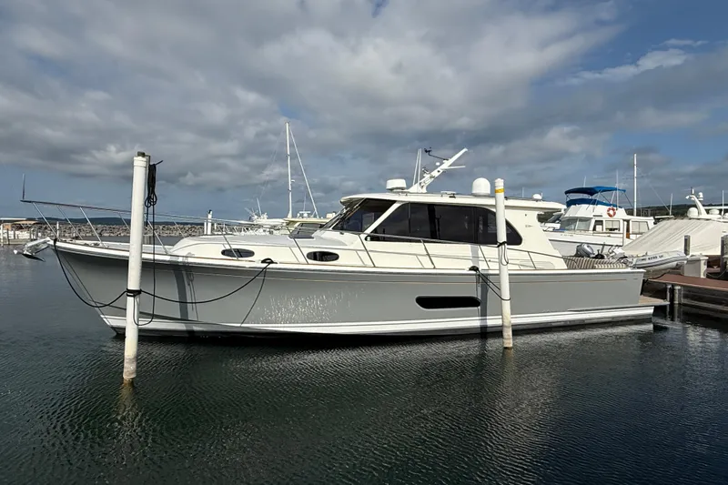  Yacht Photos Pics 2017 Grand Banks 44 Eastbay SX yacht docked in a marina under cloudy skies.