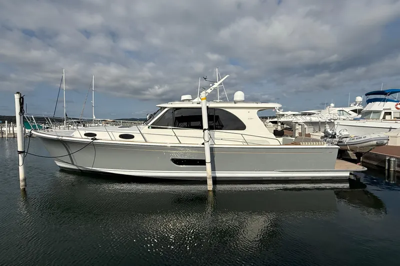  Yacht Photos Pics 2017 Grand Banks 44 Eastbay SX yacht docked at marina under cloudy sky.