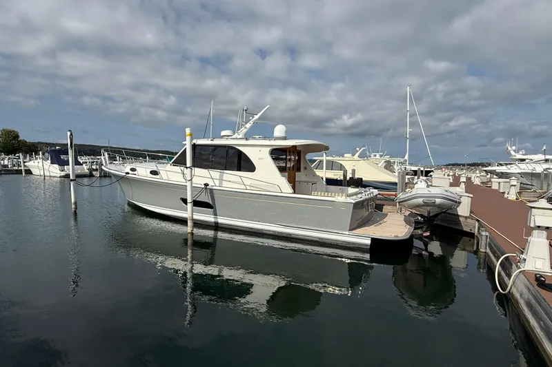  Yacht Photos Pics 2017 Grand Banks 44 Eastbay SX yacht docked at a marina under cloudy skies.
