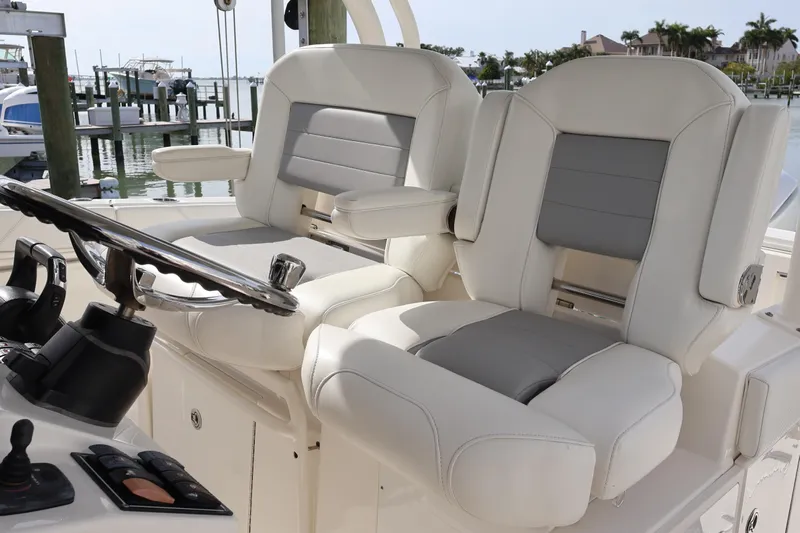  Yacht Photos Pics 2021 Pursuit S 328 Sport boat helm with luxurious seating and controls.