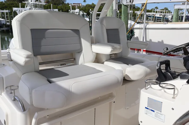  Yacht Photos Pics 2021 Pursuit S 328 Sport boat interior with dual white and gray captain seats.