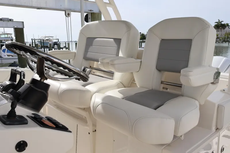  Yacht Photos Pics Luxury helm seats on 2021 Pursuit S 328 Sport boat, featuring sleek design and comfort.