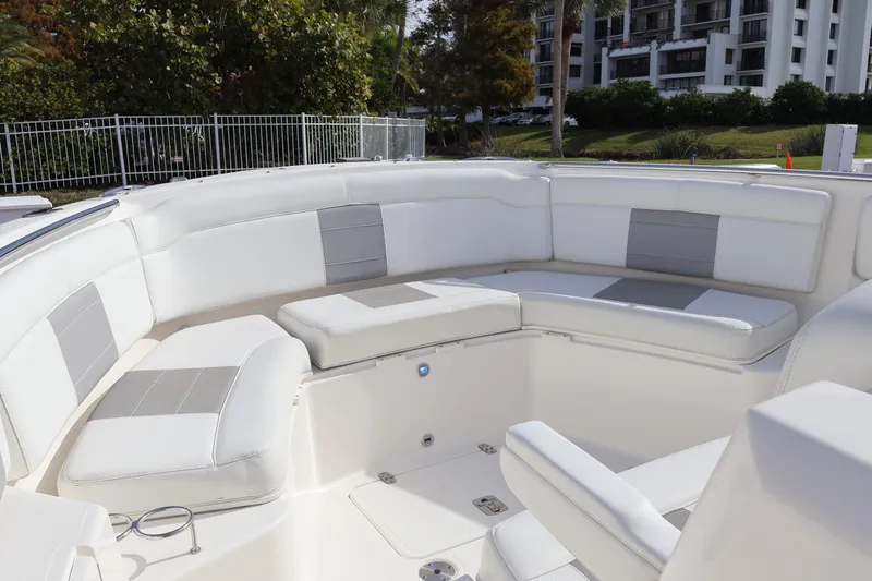  Yacht Photos Pics 2021 Pursuit S 328 Sport boat with spacious white seating area.