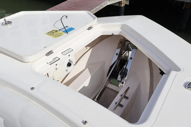  Yacht Photos Pics Anchor compartment of 2021 Pursuit S 328 Sport boat, showcasing storage and hardware.