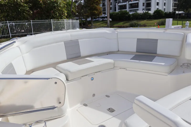  Yacht Photos Pics 2021 Pursuit S 328 Sport boat interior with white cushioned seating and modern design.
