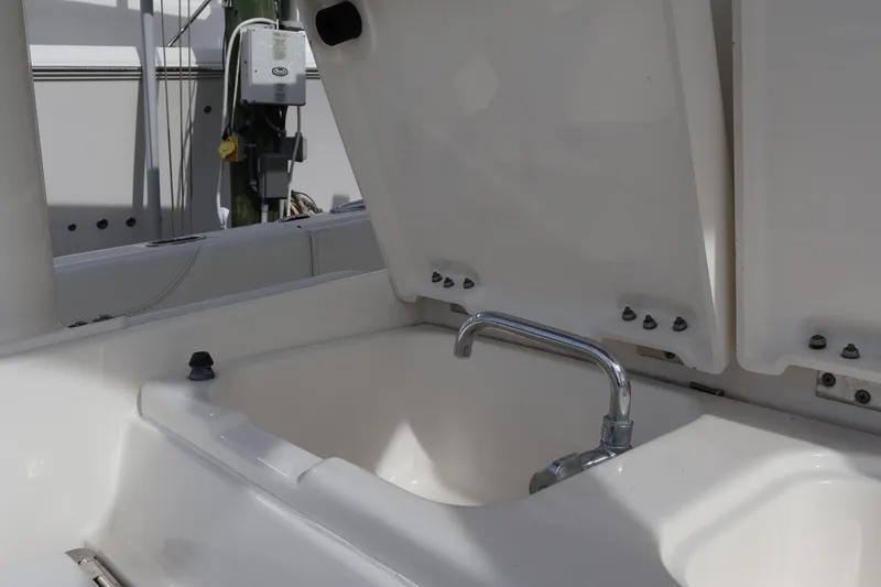  Yacht Photos Pics 2021 Pursuit S 328 Sport boat sink with open lid and faucet.