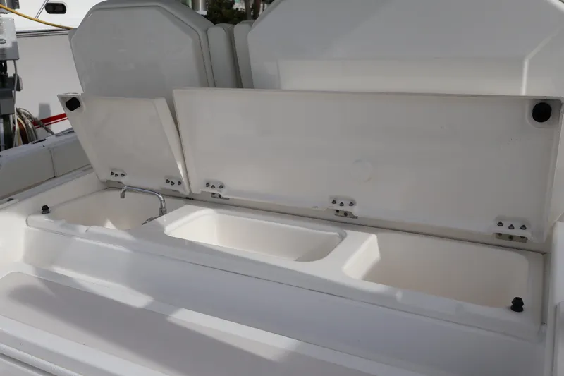  Yacht Photos Pics 2021 Pursuit S 328 Sport boat with open storage compartments and sink.