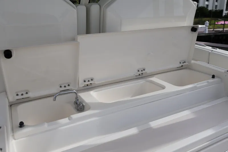  Yacht Photos Pics 2021 Pursuit S 328 Sport boat sink and storage compartments.