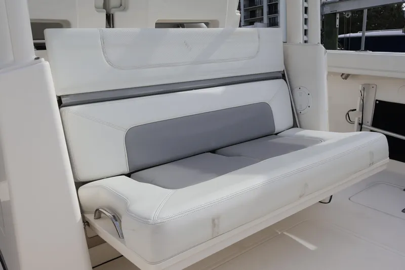  Yacht Photos Pics 2021 Pursuit S 328 Sport boat interior with white and gray cushioned seating.