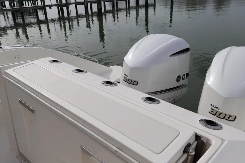  Yacht Photos Pics 2021 Pursuit S 328 Sport boat with twin Yamaha 300 engines docked by the water.