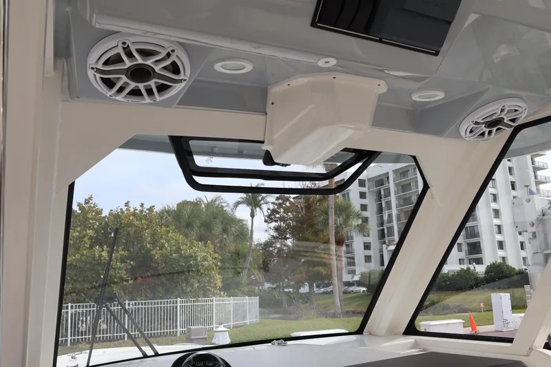  Yacht Photos Pics 2021 Pursuit S 328 Sport boat interior with speakers and windows, showcasing modern design.