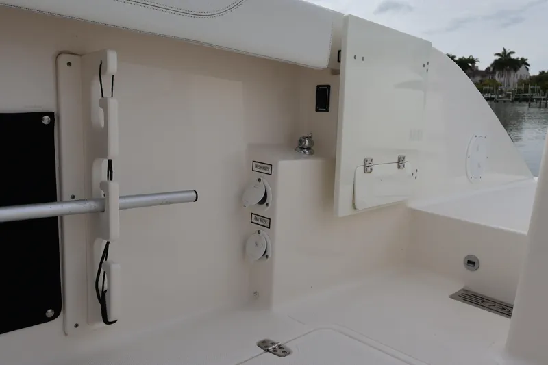  Yacht Photos Pics 2021 Pursuit S 328 Sport boat interior with storage compartments and water controls.