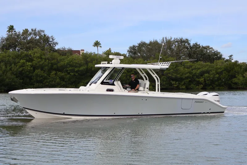  Yacht Photos Pics 2021 Pursuit S 328 Sport boat cruising on a calm waterway.