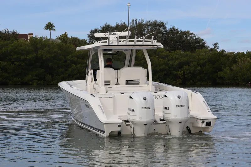  Yacht Photos Pics 2021 Pursuit S 328 Sport boat with dual Yamaha engines on a calm waterway.