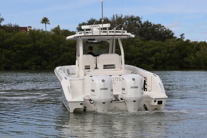  Yacht Photos Pics 2021 Pursuit S 328 Sport boat with dual Yamaha engines on a calm waterway.