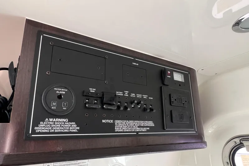 Yacht Photos Pics Electrical control panel on 2021 Pursuit S 328 Sport boat, featuring switches and warnings.