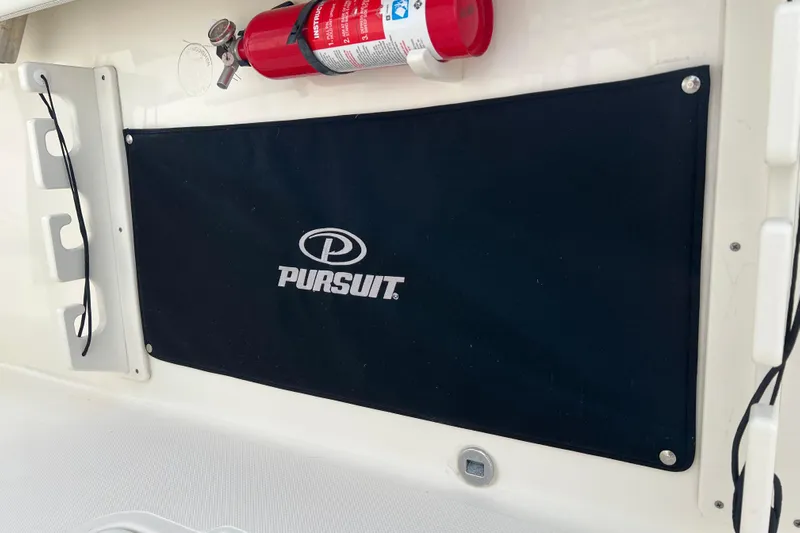  Yacht Photos Pics 2021 Pursuit S 328 Sport boat interior with fire extinguisher and branded cover.