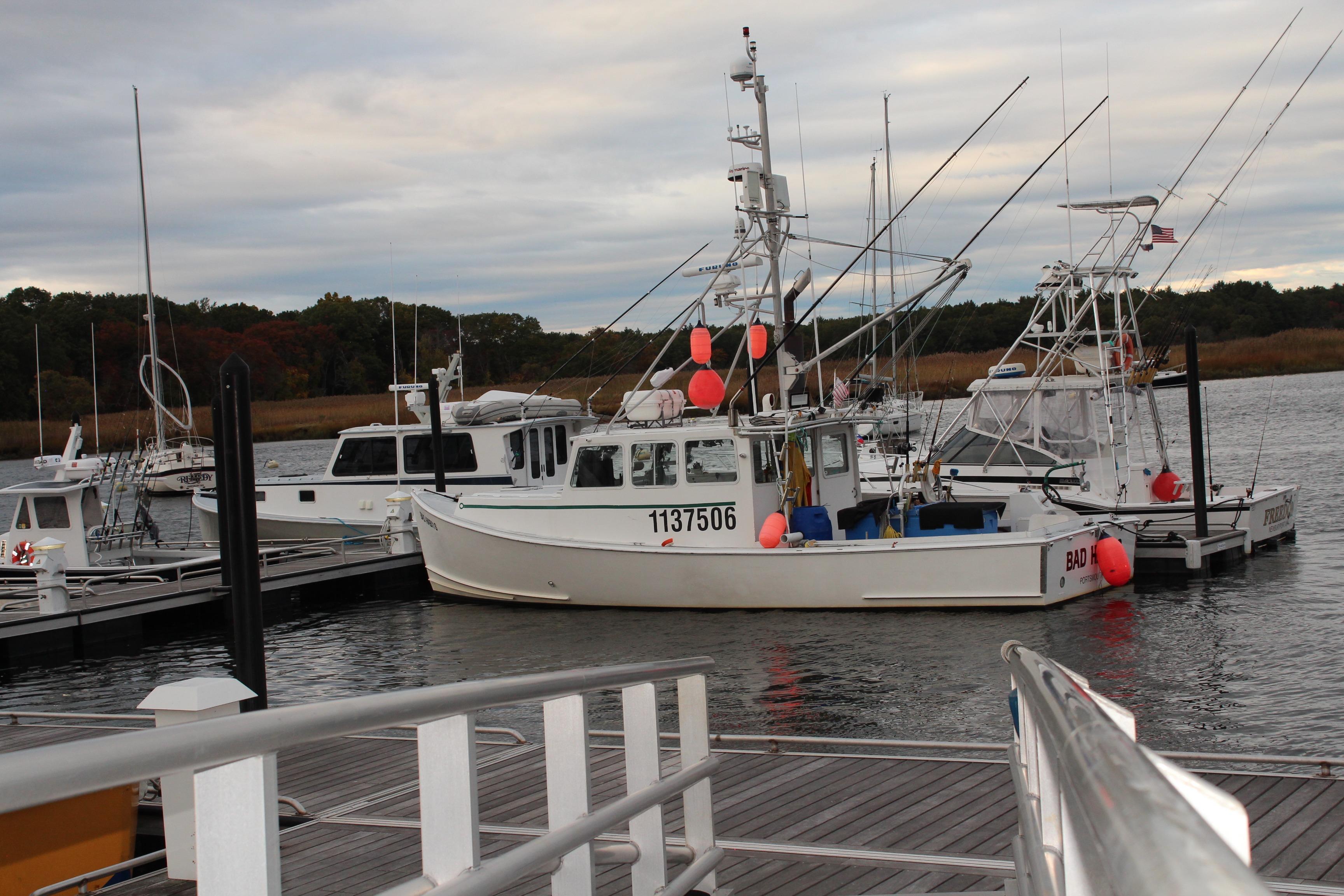 Docked 2002 Libby 38 Downeast boat with fishing equipment and buoys.