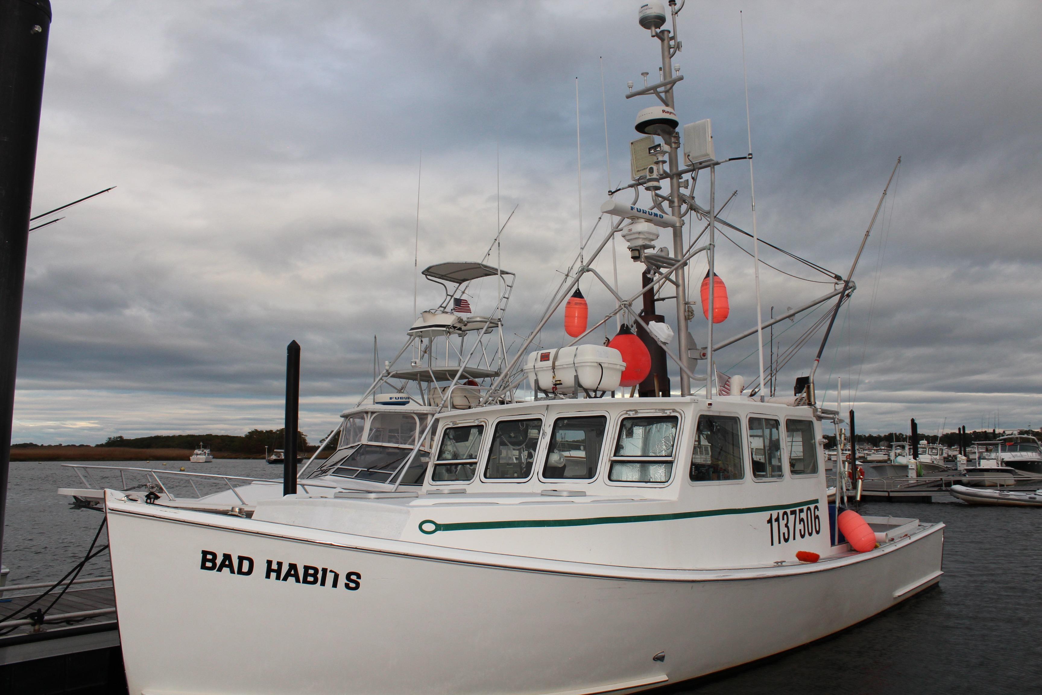 2002 Libby 38 Downeast boat named "Bad Habit" docked at a marina.