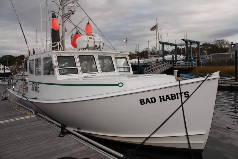 Bad Habits Yacht Photos Pics 2002 Libby 38 Downeast boat "Bad Habits" docked at marina with overcast sky.