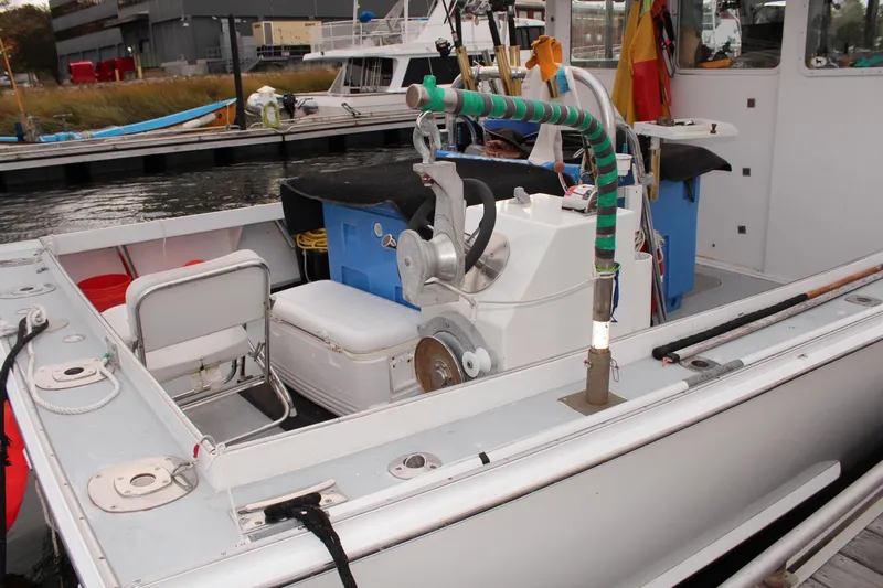 Bad Habits Yacht Photos Pics 2002 Libby 38 Downeast boat docked, featuring fishing equipment and seating area.