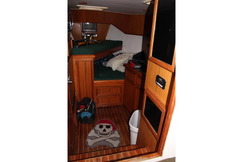 Bad Habits Yacht Photos Pics Cozy cabin interior of 2002 Libby 38 Downeast boat with wooden furnishings.